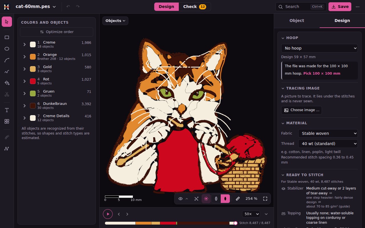 The cat in the shapes view: fills and satins as flat color areas, at the bottom right of the stage the switch Stitches | Shapes next to the eye